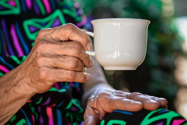 A Beulah Lodge resident holding a cup